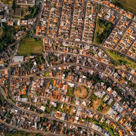 A densely populated urban area with winding streets and compact housing, illustrating city growth, infrastructure development, and urban planning.